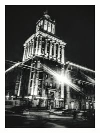 Illuminated buildings against sky at night