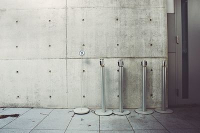Stanchions against wall of building