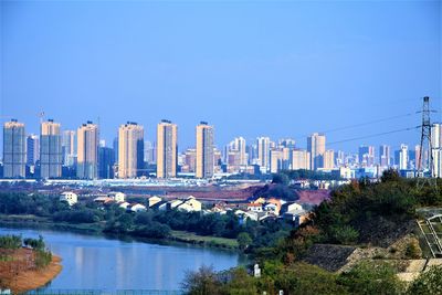 View of cityscape against clear blue sky