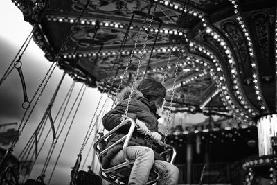 Low angle view of people at amusement park