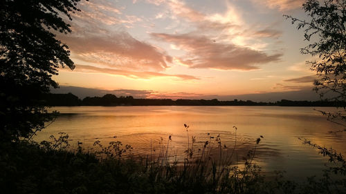 Scenic view of lake at sunset