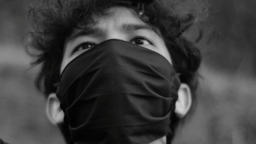 Close-up portrait of man covering face