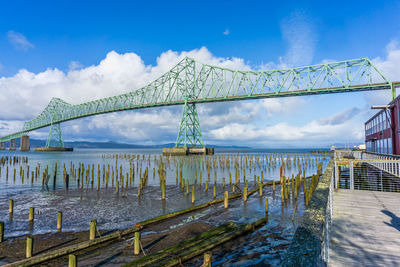 A view of the astoria-megler bridge that spans the columbia river. old pilings in the foreground.