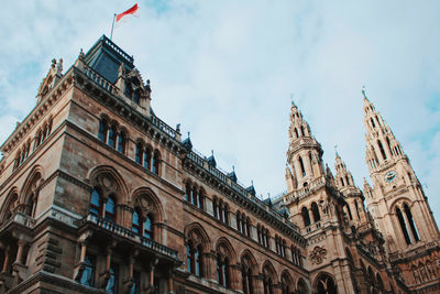 Low angle view of building against cloudy sky