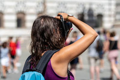 Rear view of woman photographing