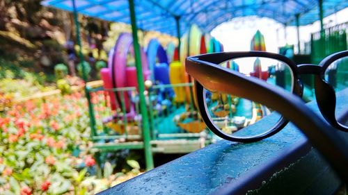 Close-up of eyeglasses on retaining wall