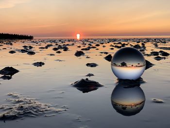 Scenic view of sea against sky during sunset