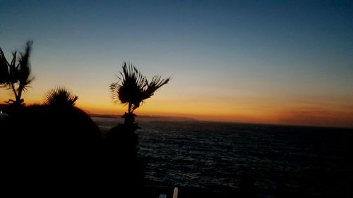 Scenic view of sea against clear sky during sunset