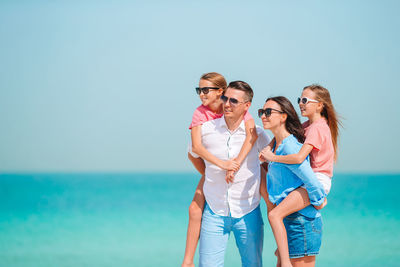 Family looking away while standing on beach