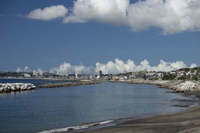 Scenic view of sea and buildings against sky