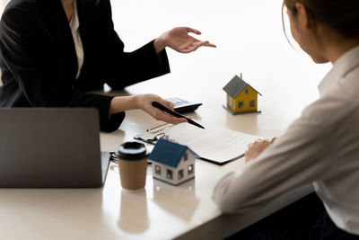 Midsection of business colleagues working at office