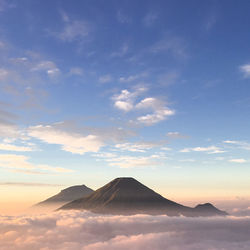 Scenic view of snowcapped mountain against cloudy sky