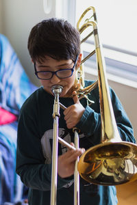 Cute boy playing trumpet