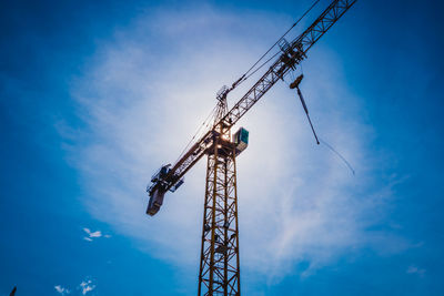 Low angle view of crane against sky