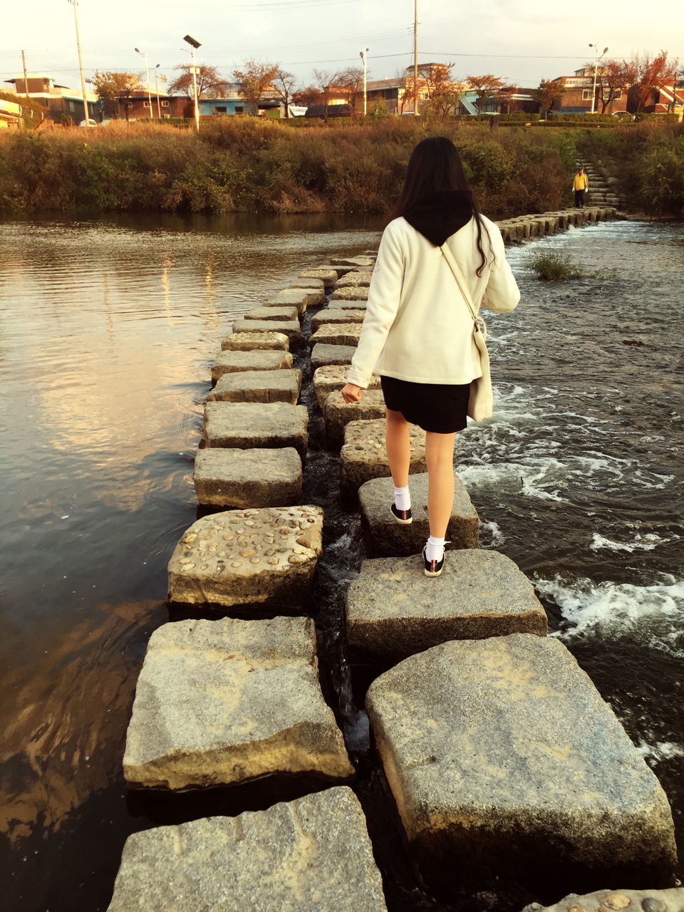 water, full length, rear view, lifestyles, leisure activity, casual clothing, standing, walking, person, built structure, men, river, day, the way forward, building exterior, outdoors, architecture, pier