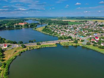 High angle view of river amidst city against sky