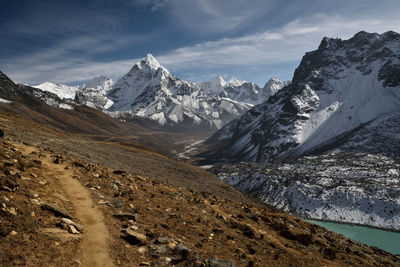 Scenic view of mountains against cloudy sky