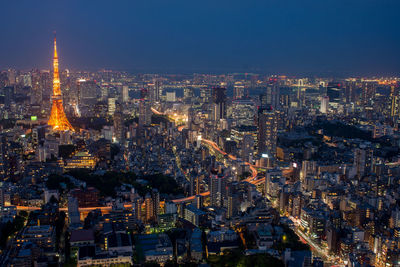 High angle view of city lit up at night