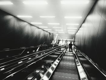 High angle view of man standing on illuminated escalator