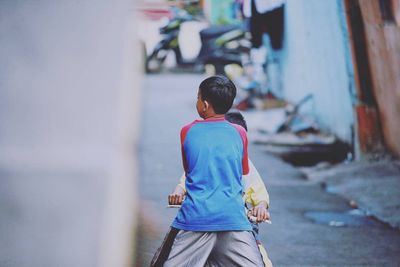 Rear view of boy walking outdoors