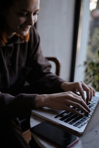 Smiling woman using laptop