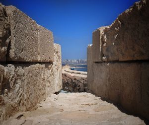 Stone wall against clear blue sky