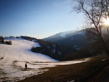 Scenic view of snow covered land against sky