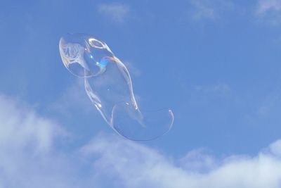 Low angle view of bubble against blue sky