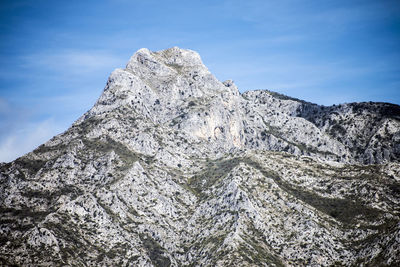 Low angle view of snowcapped mountain against sky