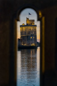 View through balustrade of the old harbor of la rochelle at blue hour with its famous old towers.