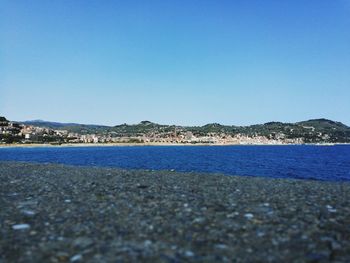 Surface level of sea against clear blue sky