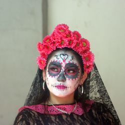 Portrait of woman with pink flower