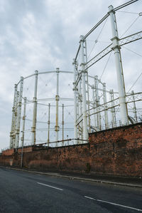 Low angle view of electricity pylon against sky