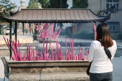 Women with incense sticks in background