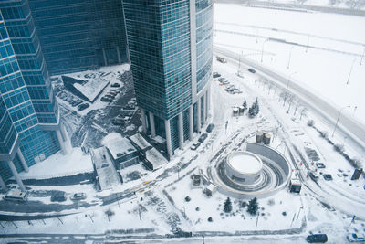 High angle view of modern buildings in city during winter