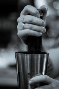 Cropped hands of woman holding mortar and pestle