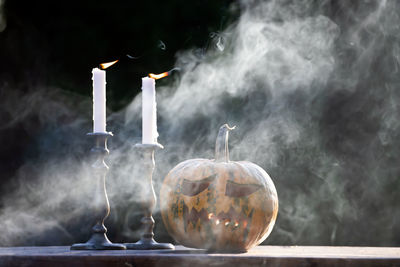 Close-up of lit candles in temple