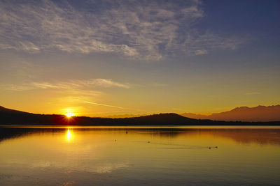 Scenic view of lake against sky during sunset