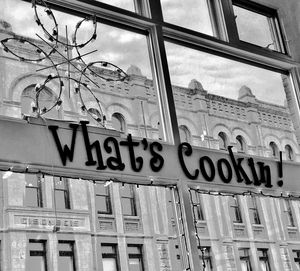 Low angle view of text on building against sky