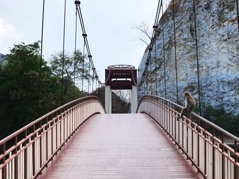 Low angle view of footbridge against sky