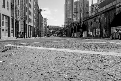 Surface level of city street against cloudy sky