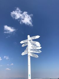 Low angle view of directional signs against sky