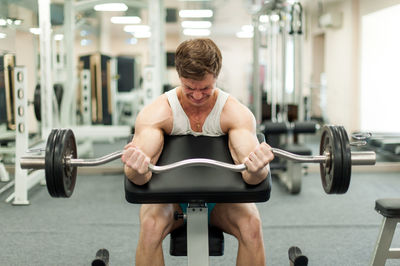 Young man exercising in gym