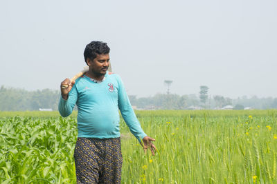 Full length of man standing on field