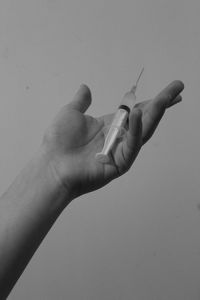 Close-up of hand holding hands over white background