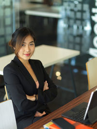 Portrait of smiling young businesswoman sitting in office