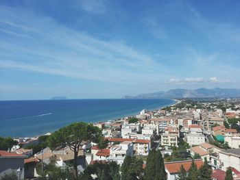 High angle view of townscape by sea against sky