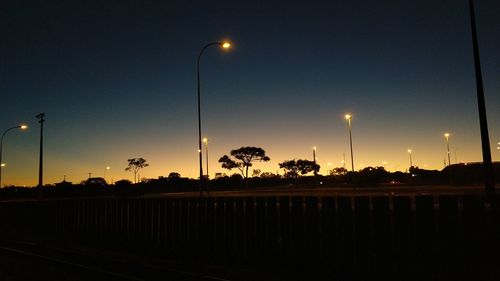 Silhouette street against sky at night