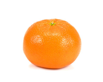 Close-up of orange apple against white background