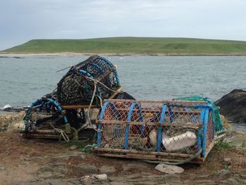 View of fishing net on sea against sky